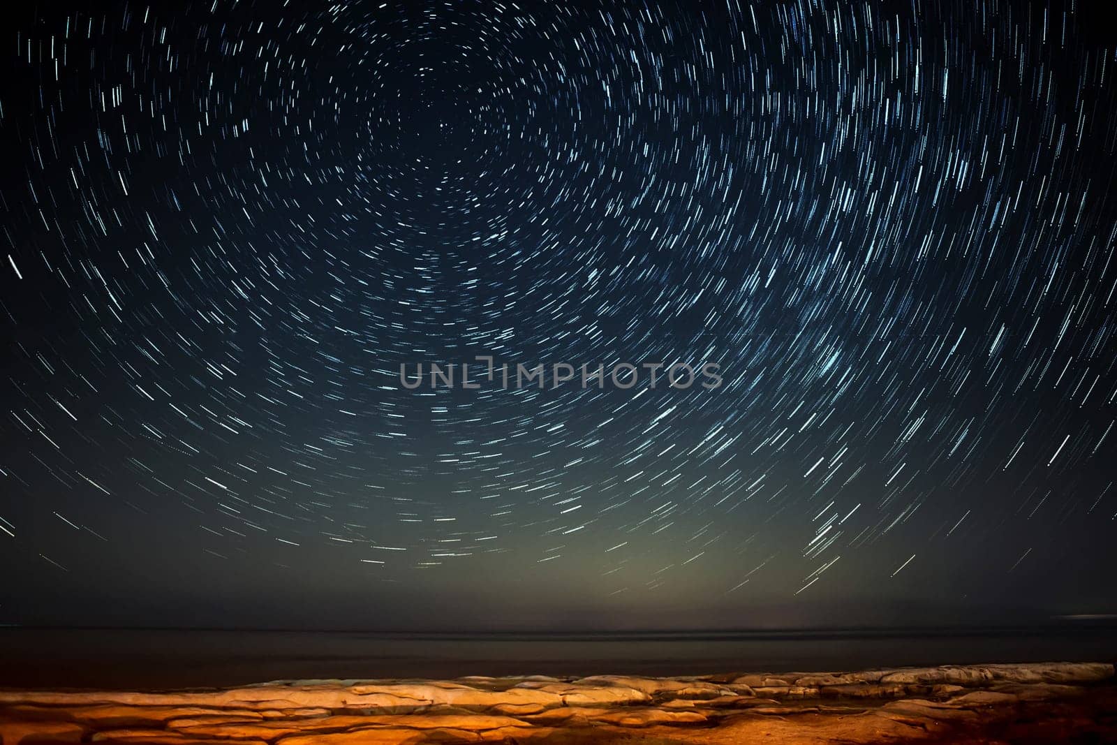 Extreme long exposure image showing star trails around the Polar Star or Polaris over Selmun in Malta