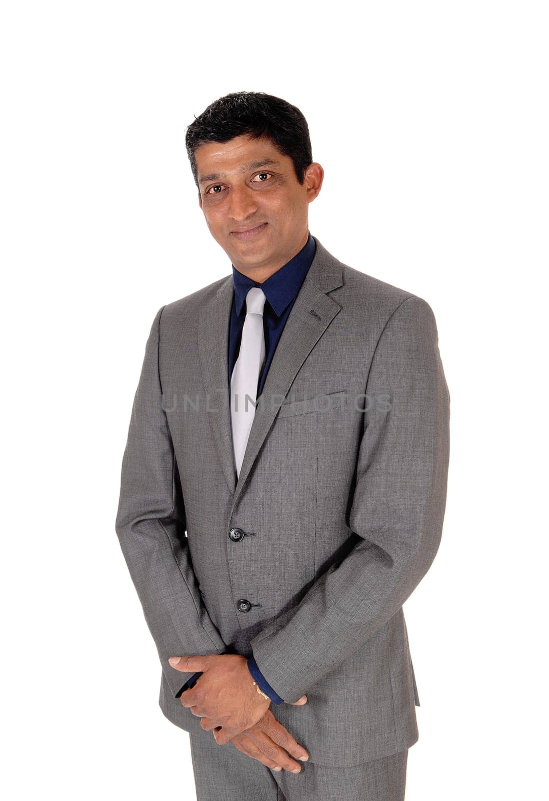 A waist up image of a handsome business man in a gray suit and blue.shirt standing isolated for white background.