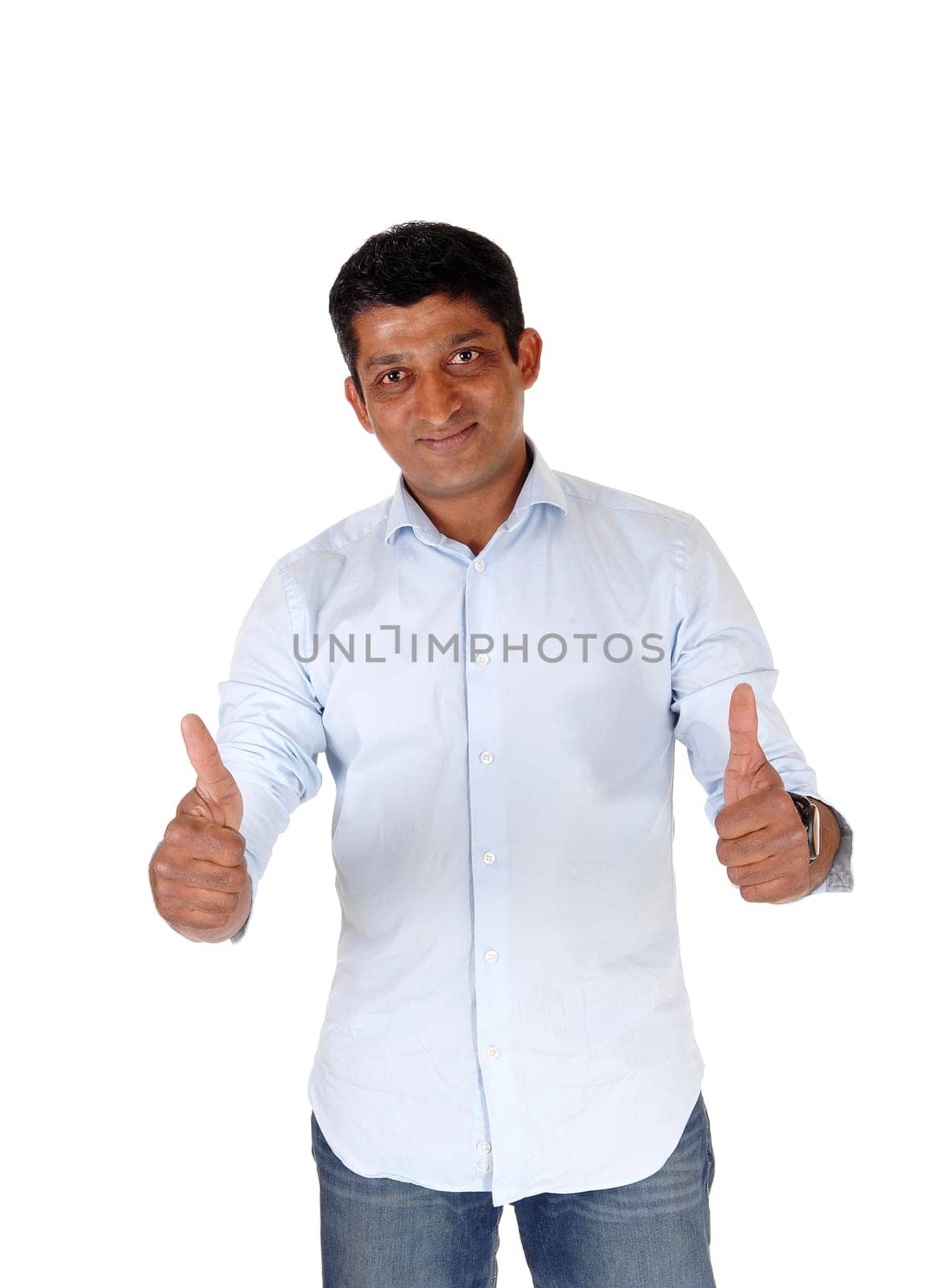A closeup image on an East Indian man in jeans and blue shirt standing.with booths of his thumps up, isolated for white background.
