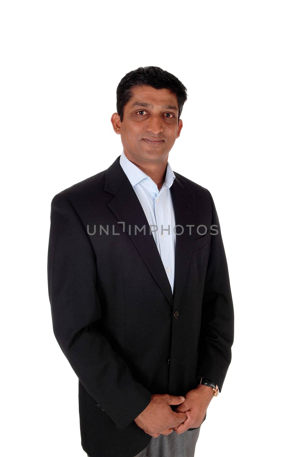 A waist up image of a handsome business man in a black jacket and .light blue shirt standing isolated for white background.