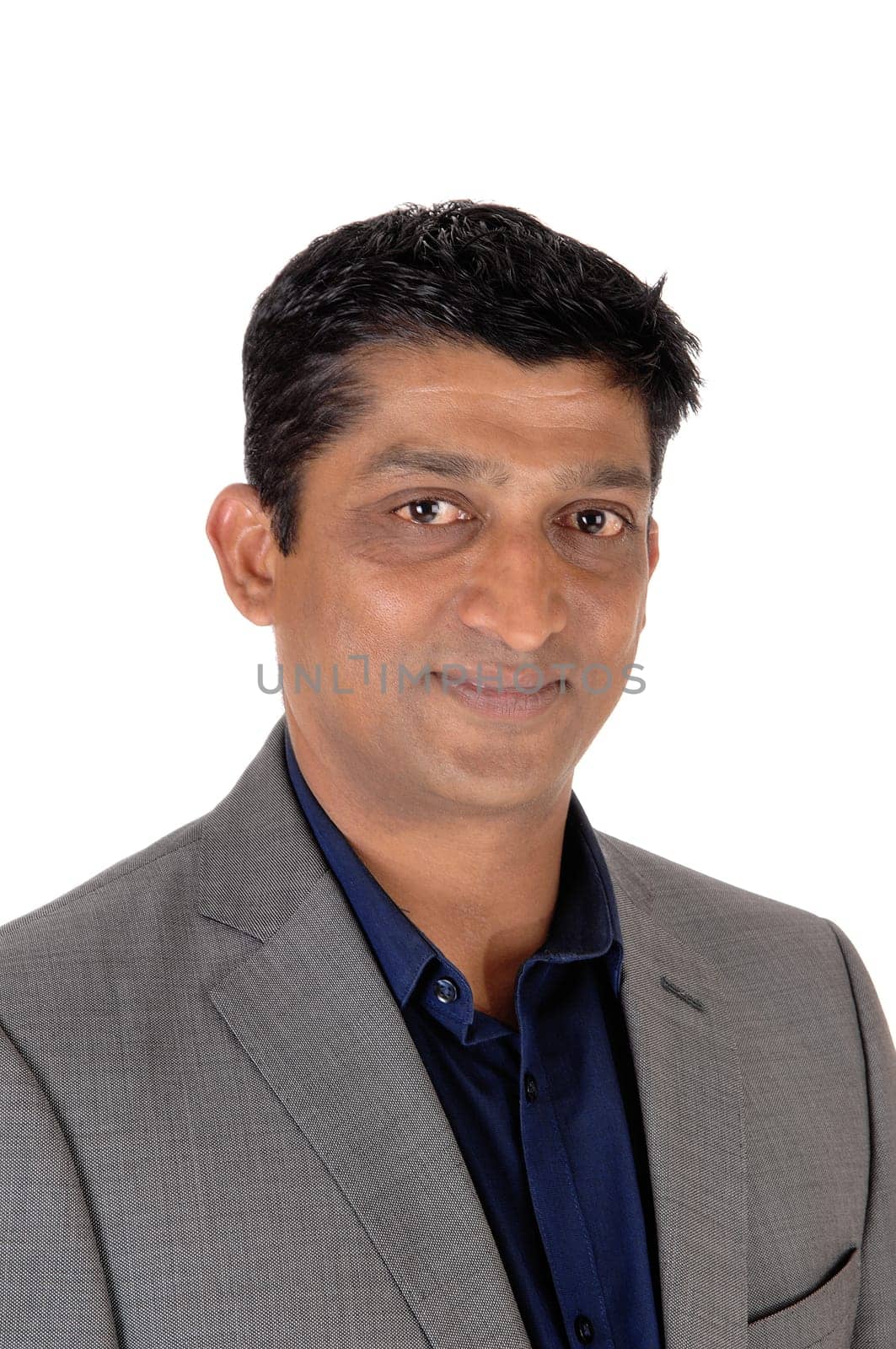 A handsome east Indian businessman in a gray suit and black hair.in a closeup image, isolated for white background.