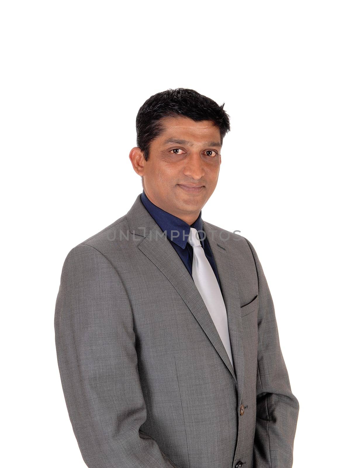 A handsome east Indian businessman in a gray suit and black hair.looking into the camera, isolated for white background.