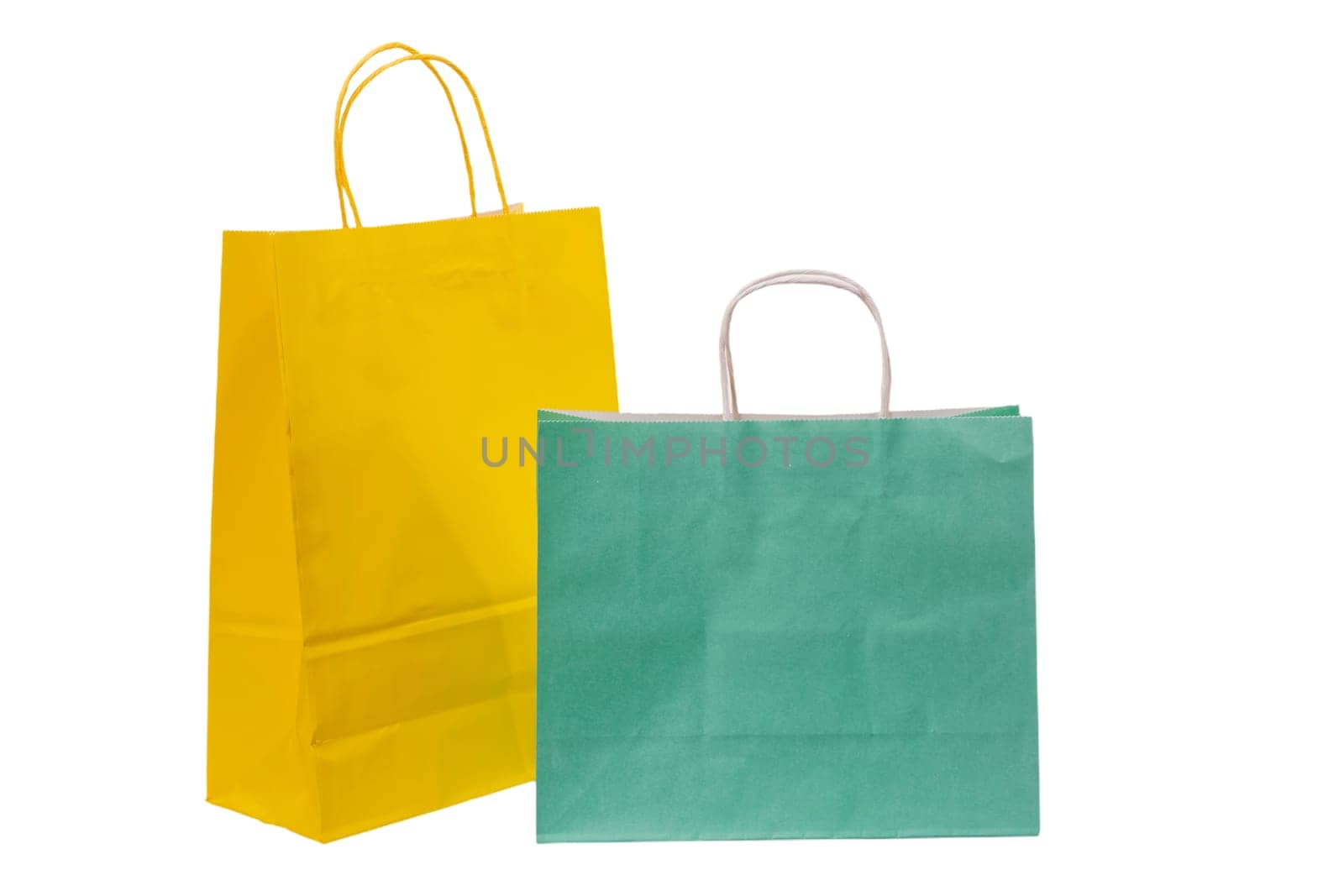 Variety of colored paper shopping bags on white background. Empty area.
