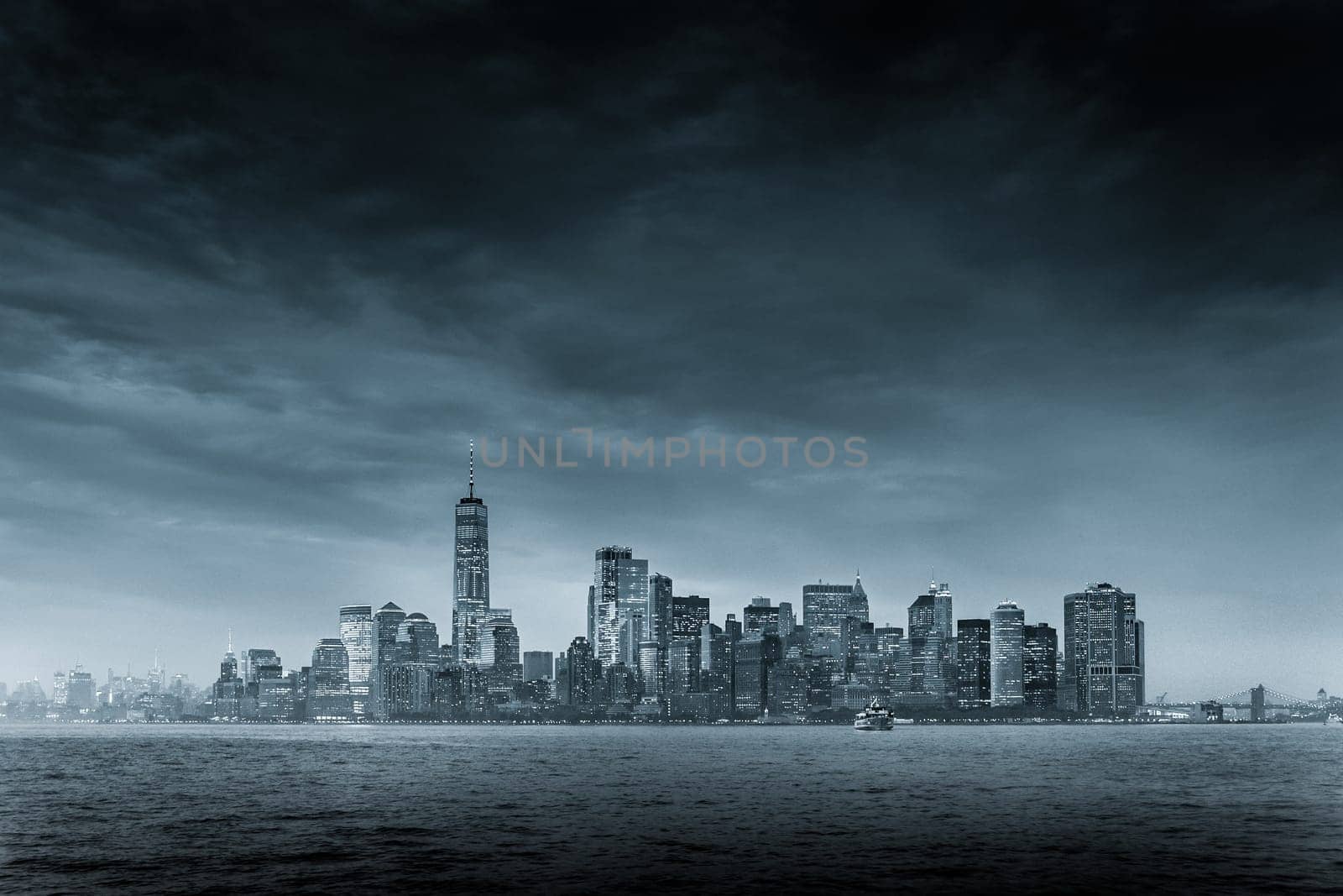 Dramatic panoramic view of storm over Lower Manhattan from Ellis Island at dusk, New York City.