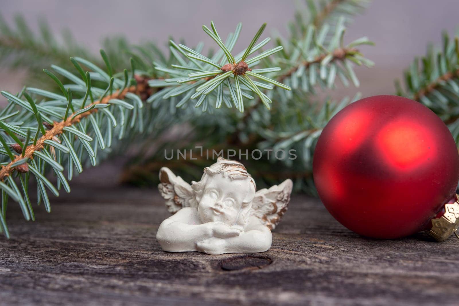 christmas sill with angel,fir branch and x-mas ball on wooden ground