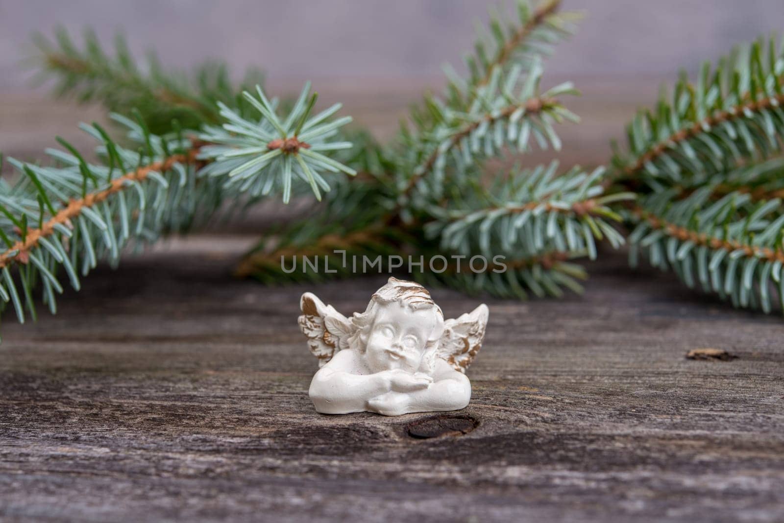 christmas sill with angel and fir branch on wooden ground