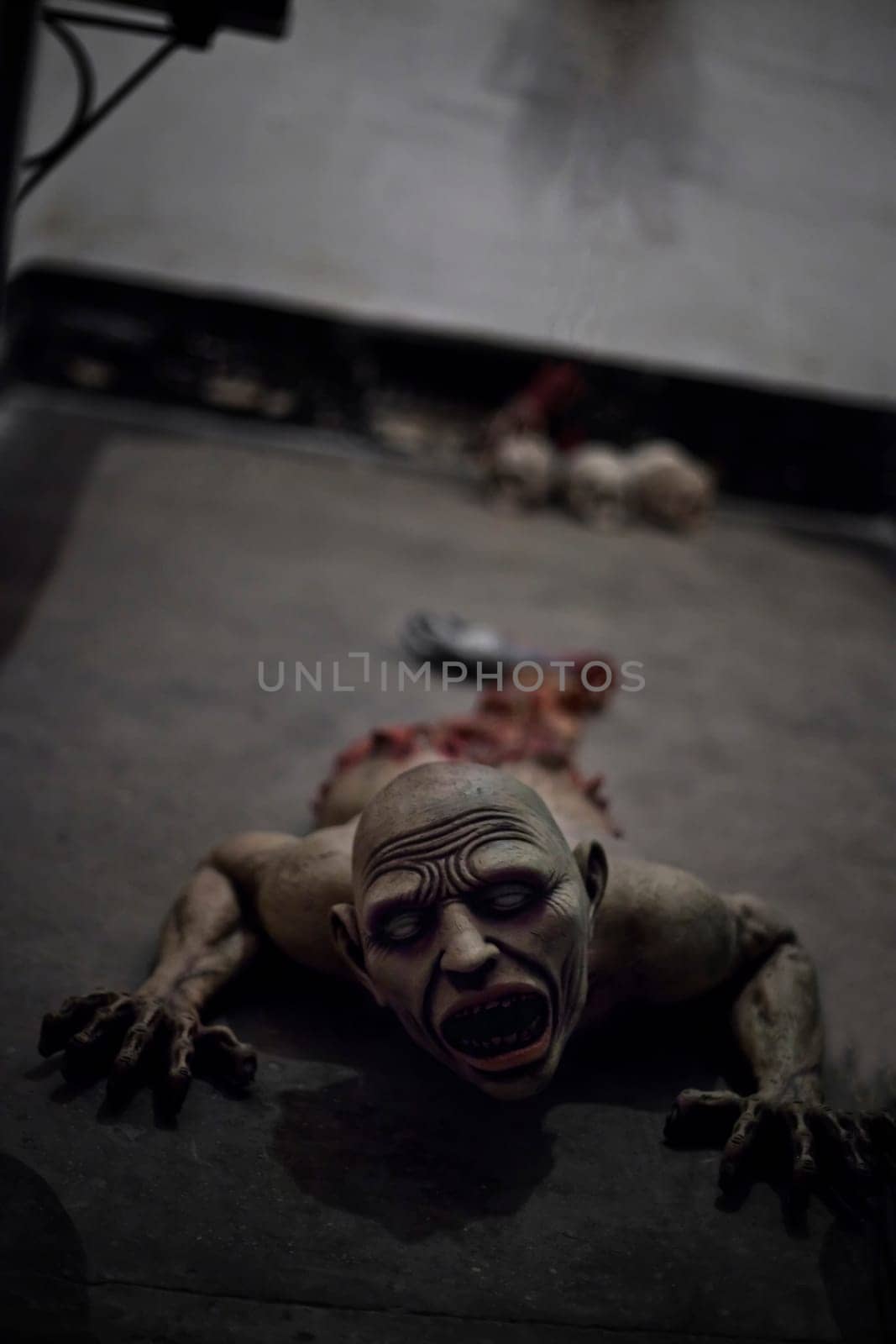 A dismembered zombie or ghoul crawling on the floor