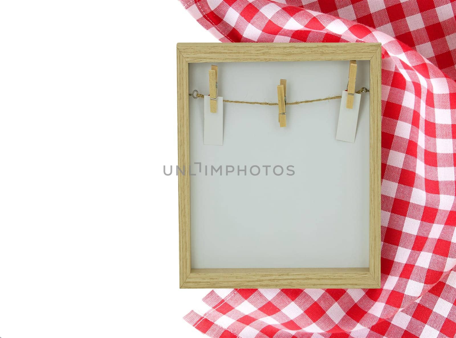 Food recipe template. Empty wooden frame and a red white checkered cloth isolated on white background. For your food and product display montage. Copy space on left side.