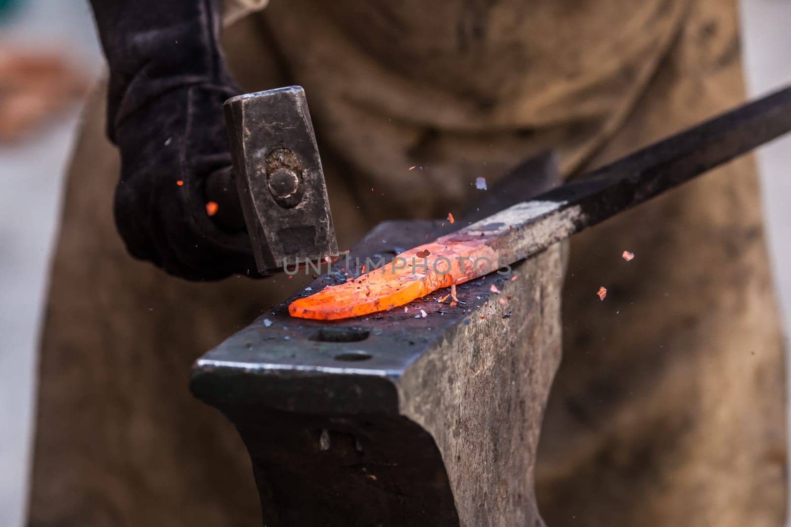 Detail shot of metal being worked at a blacksmith forge