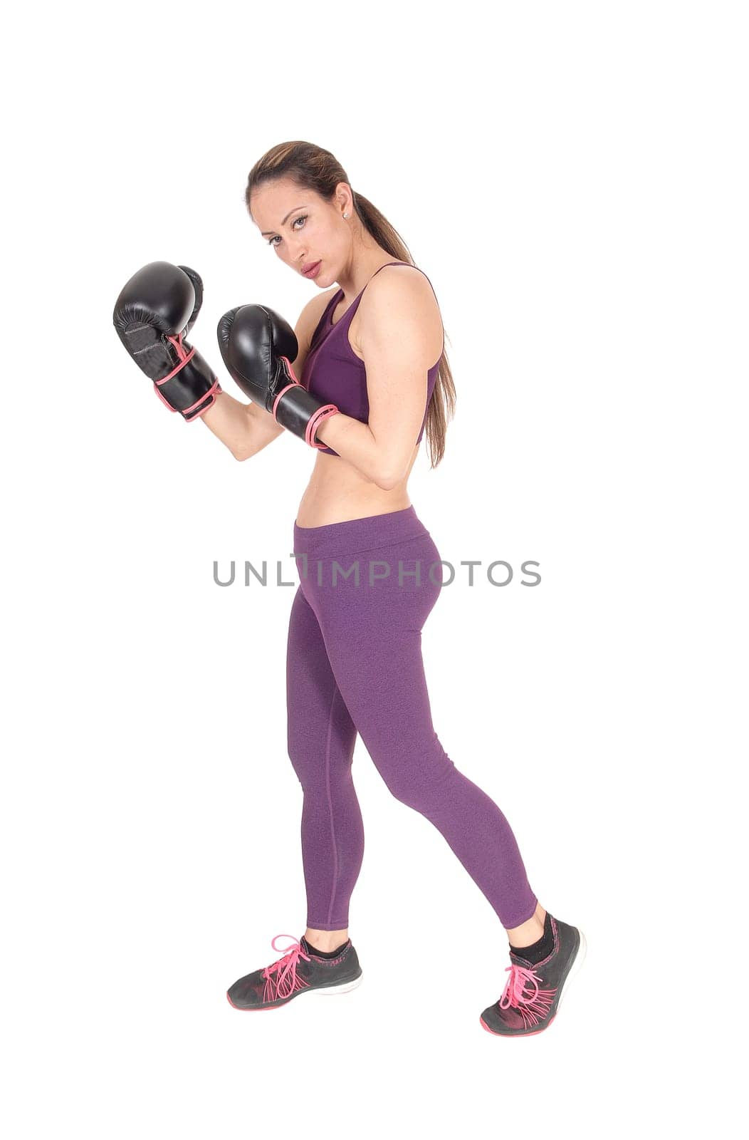 A full body image of a woman boxing and in workout outfits standing.isolated for white background.