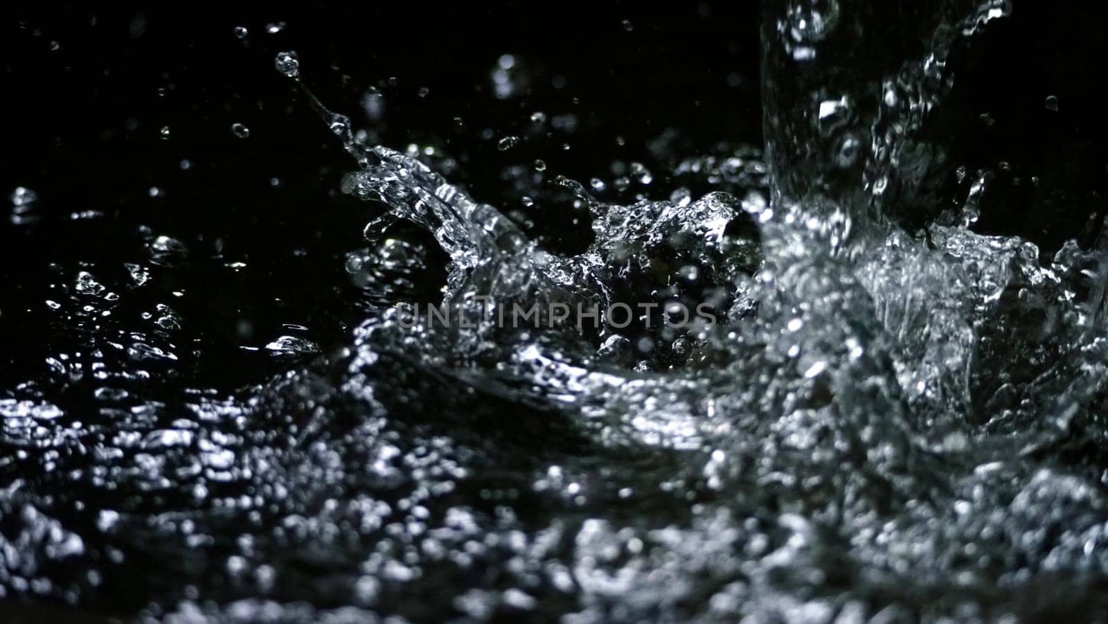 Water splash on black background color which represent clean and pure natural freshness of liquid for healthy drink or sparkling water