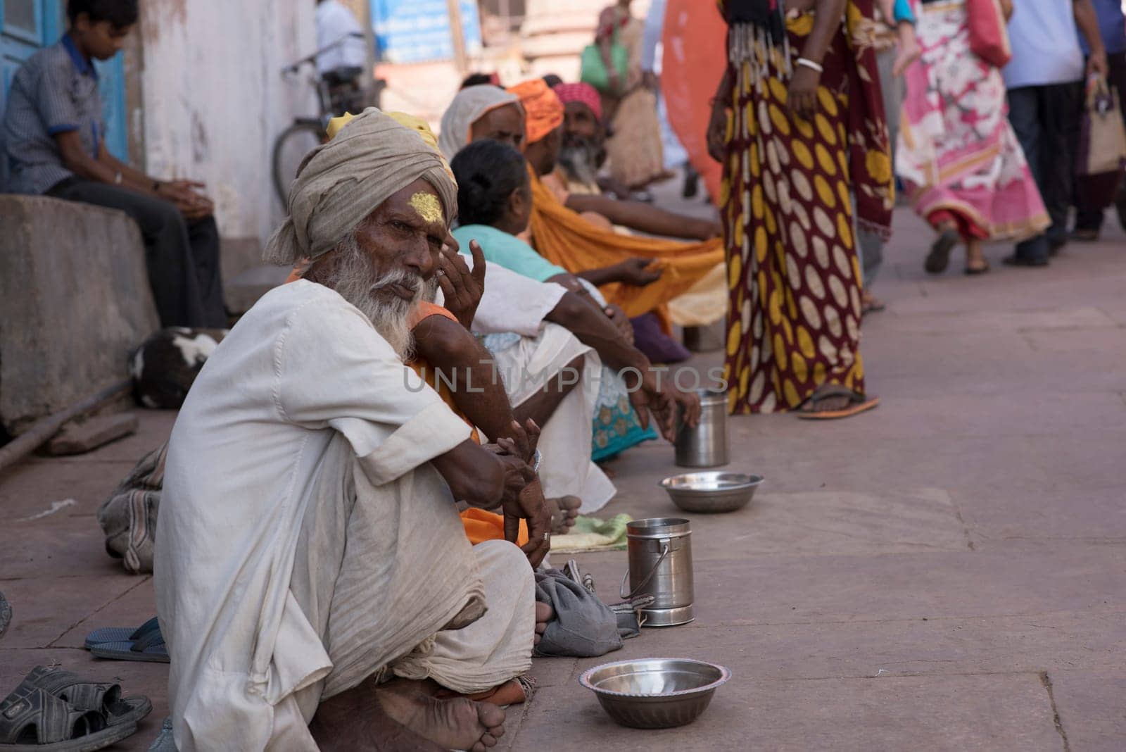 Mathura, Agra, India – October 13, 2016: Line of beggars seeking alms from worshipers outside a temple in Mathura, India.