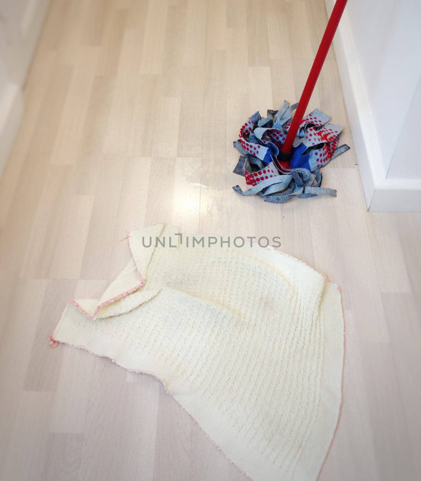 cleaning the floor with a mop and a rag