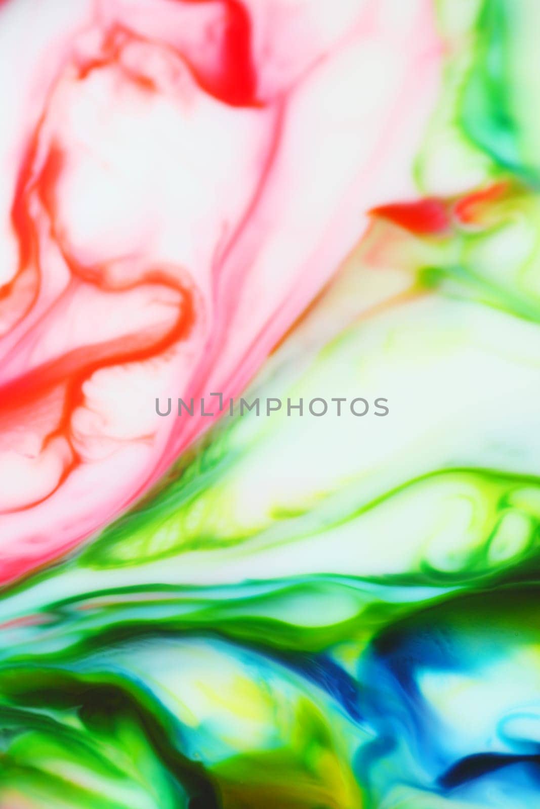 Paints in red, green, yellow and blue on a white background