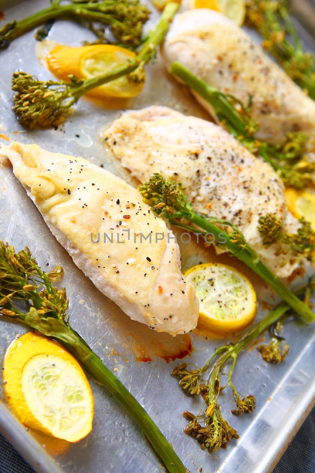 Chicken breasts with broccolini and yellow squash in natural light