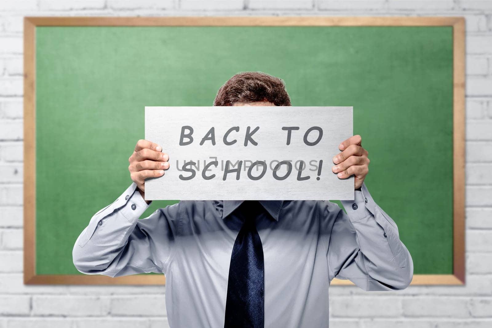 Young college student with back to school message against chalkboard background