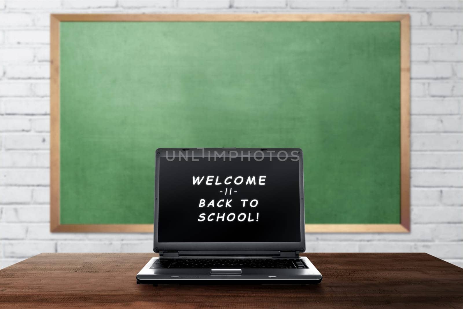 Welcome back to school text on laptop screen on the classroom