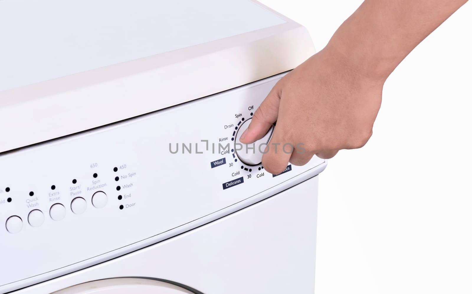 Close up of hand adjusting washing machine program isolated over white background