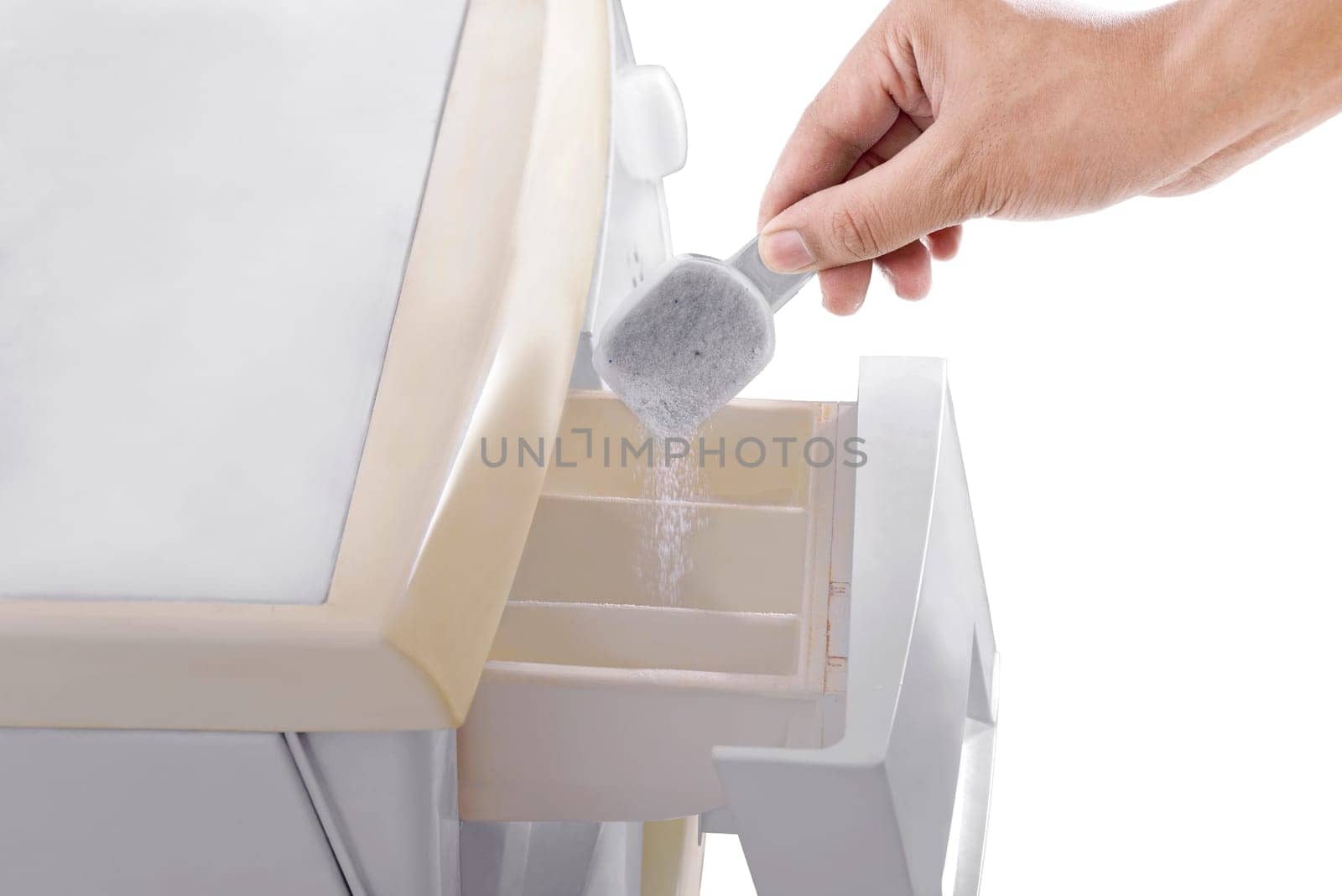 Human hands put the detergent into the washing machine isolated over white background