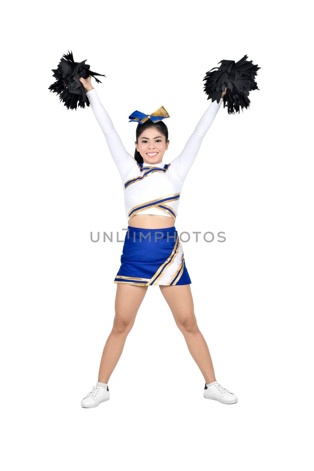 Happy asian cheerleader with pom poms in the air isolated over white background