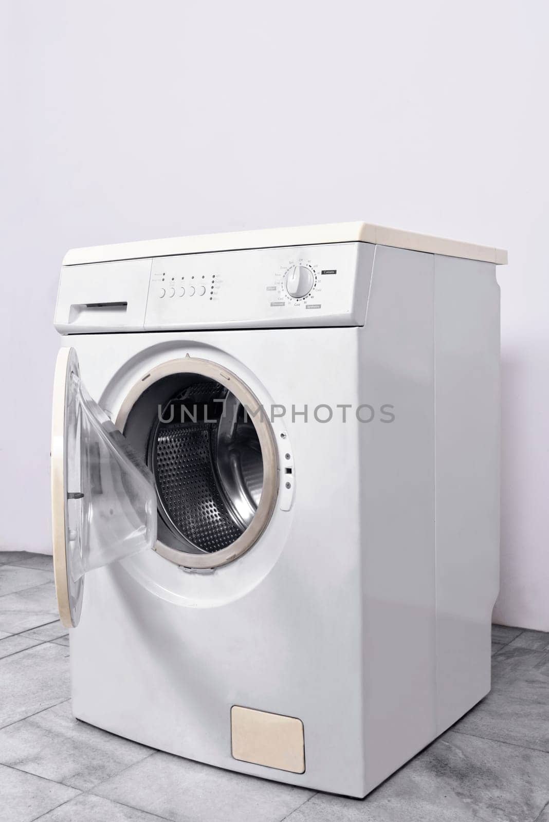Washing machine with open door at home. Home appliances