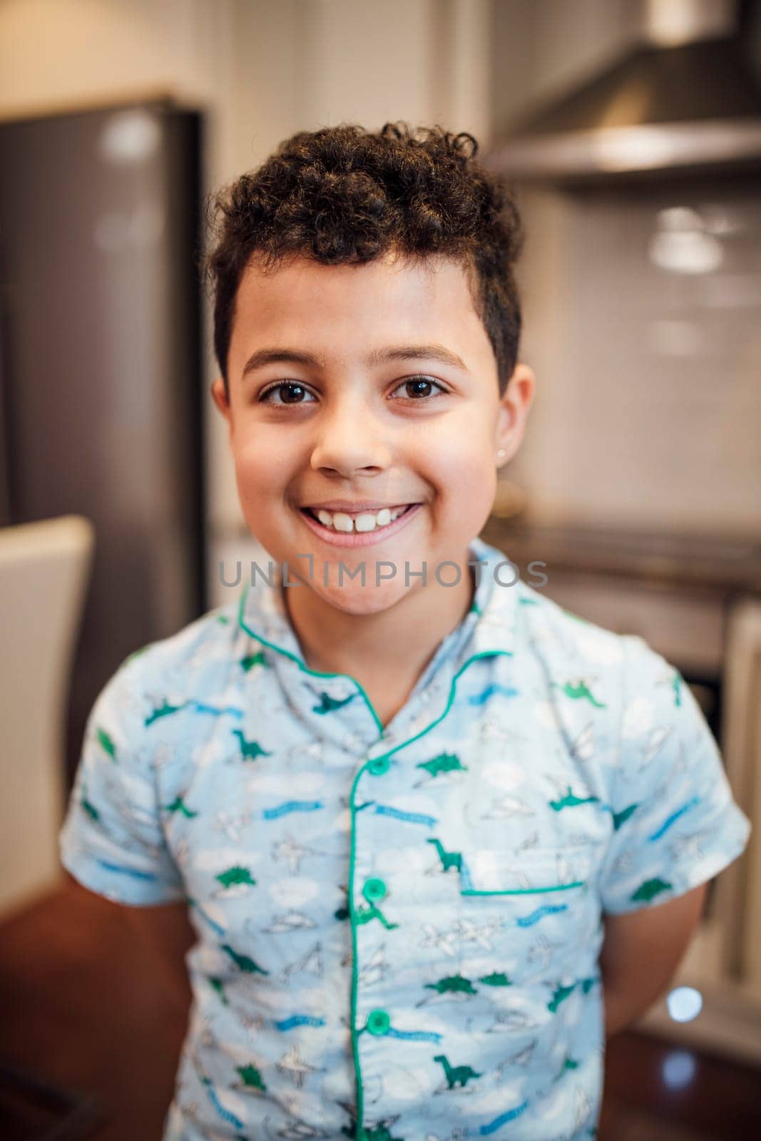 Potrait of a little boy at home in the morning wearing pyjamas.