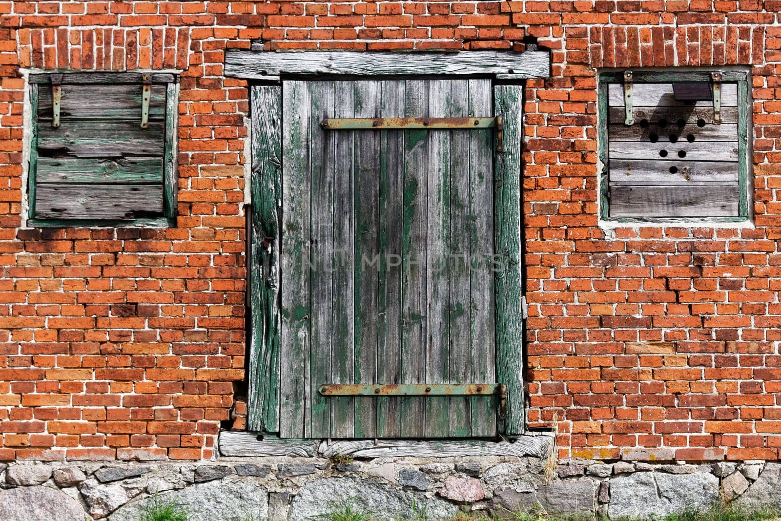 red house with old wooden door and wooden windows