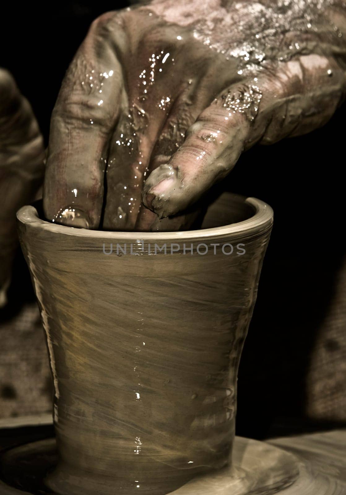 Detail of a potter's hand while creating a new work of art