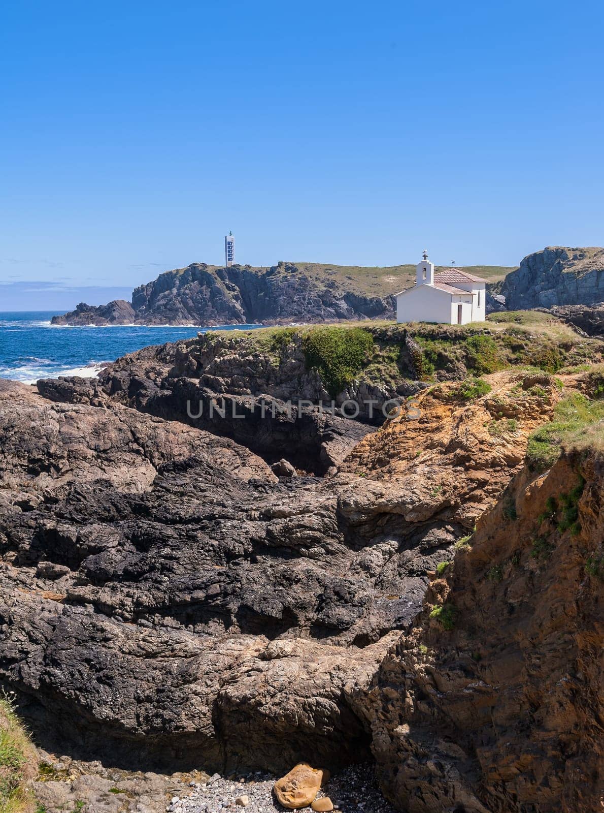 The hermitage of the Virgen del Puerto in Meirás, A Coruna, Galicia, Spain.Landscape of the coast of Galicia, lighthouse.