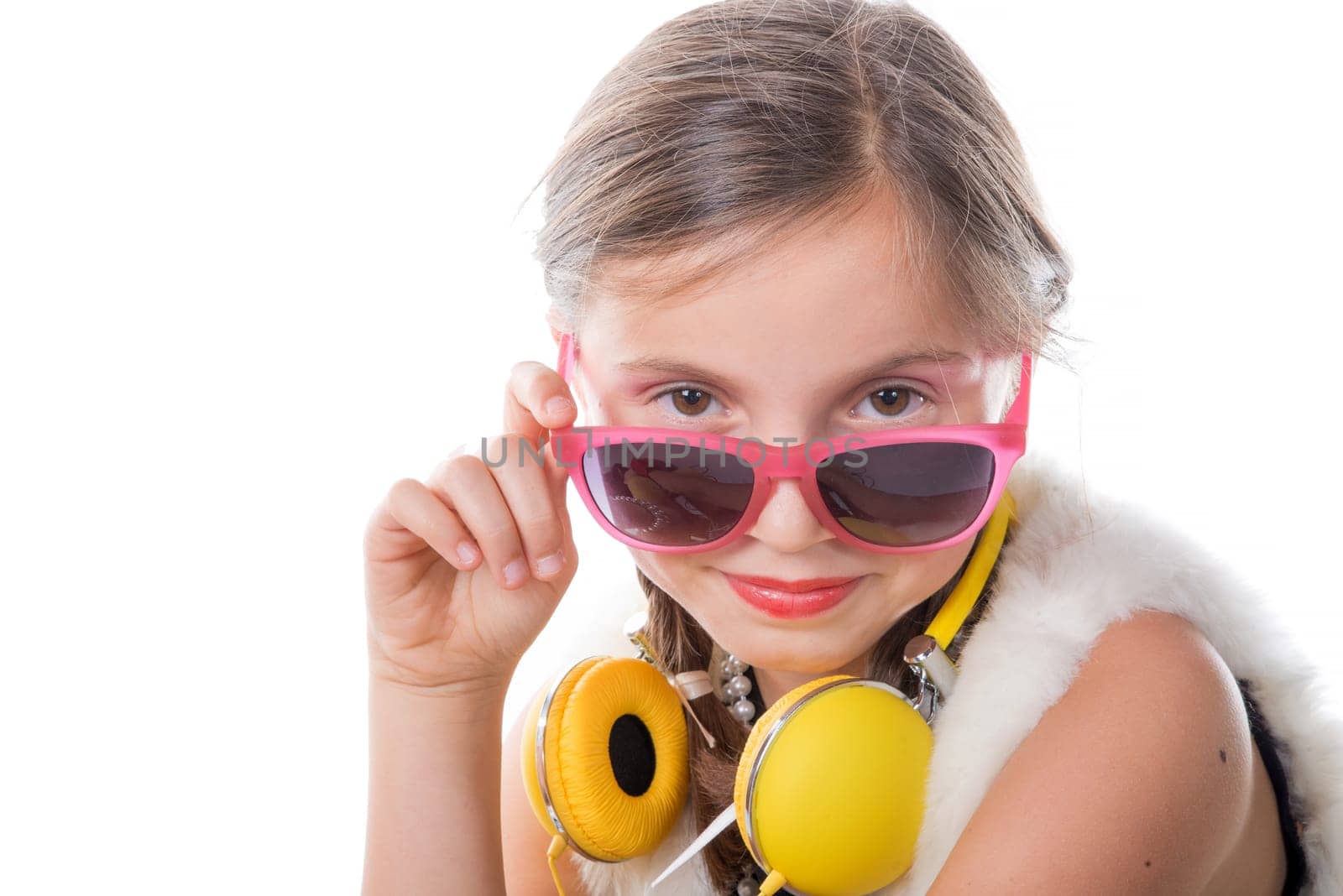 a pretty little girl with pink glasses and yellow headphones on white background
