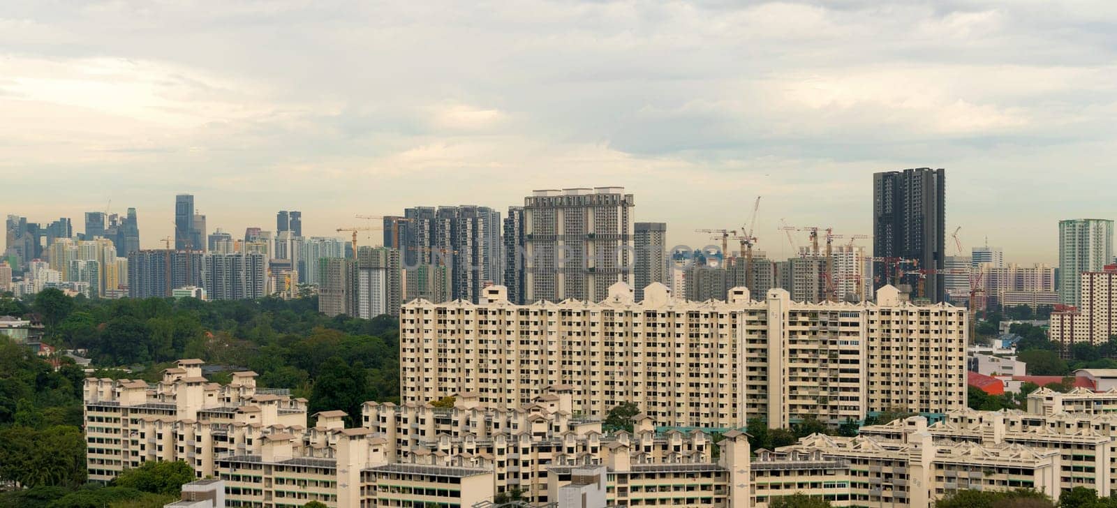 Singapore apartment housing real estate boon with construction cranes cityscape panorama
