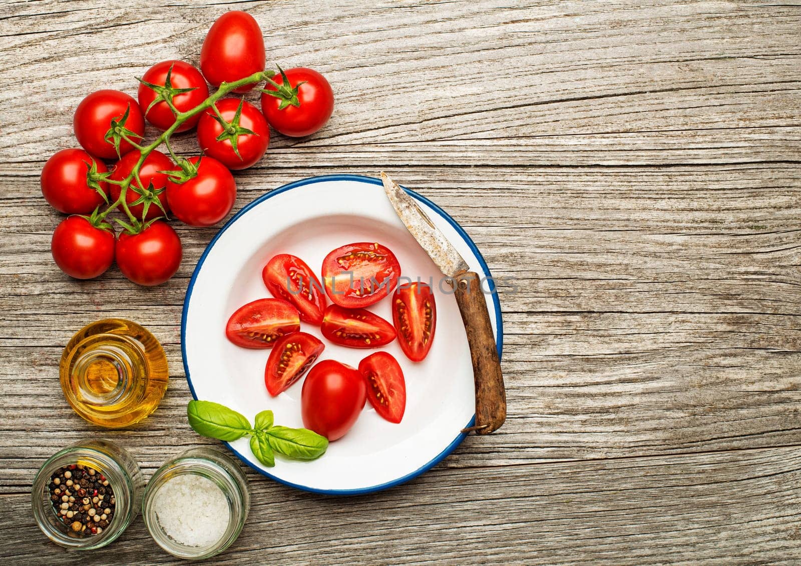 Fresh tomatoes with spices on wooden background. Top view