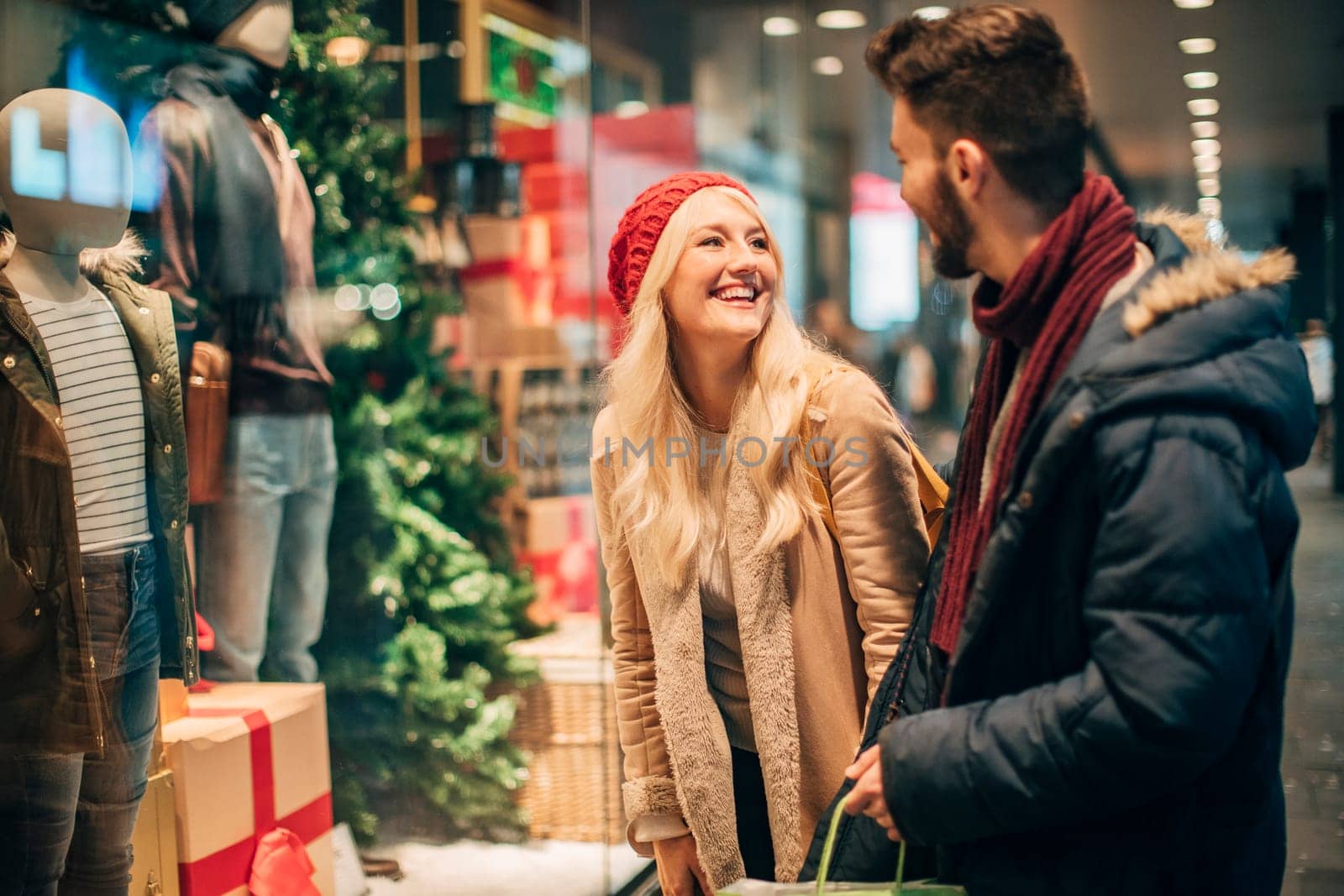 Side view of two mid-adult people window shopping at chirtsmas time.