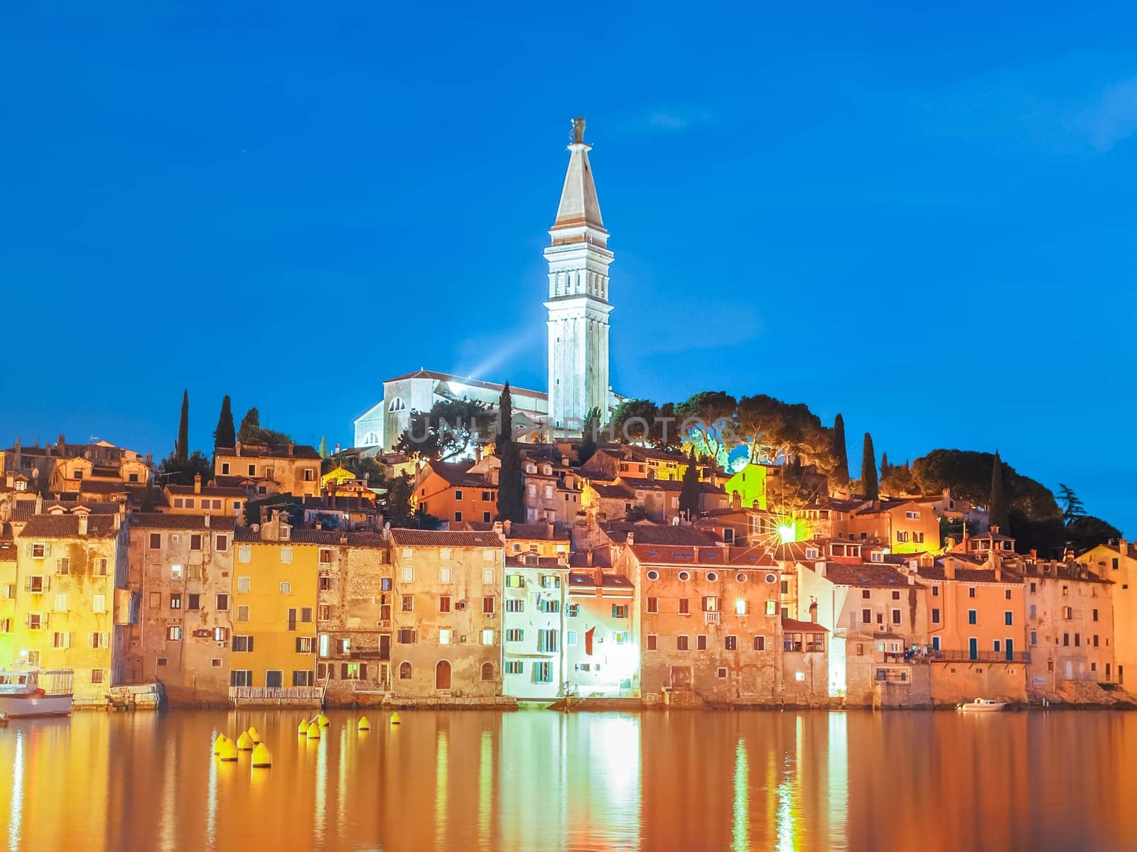 Colorful sunset of Rovinj town, Croatian fishing port on the west coast of the Istrian peninsula. Colorful evening seascape of Adriatic Sea. Traveling concept.
