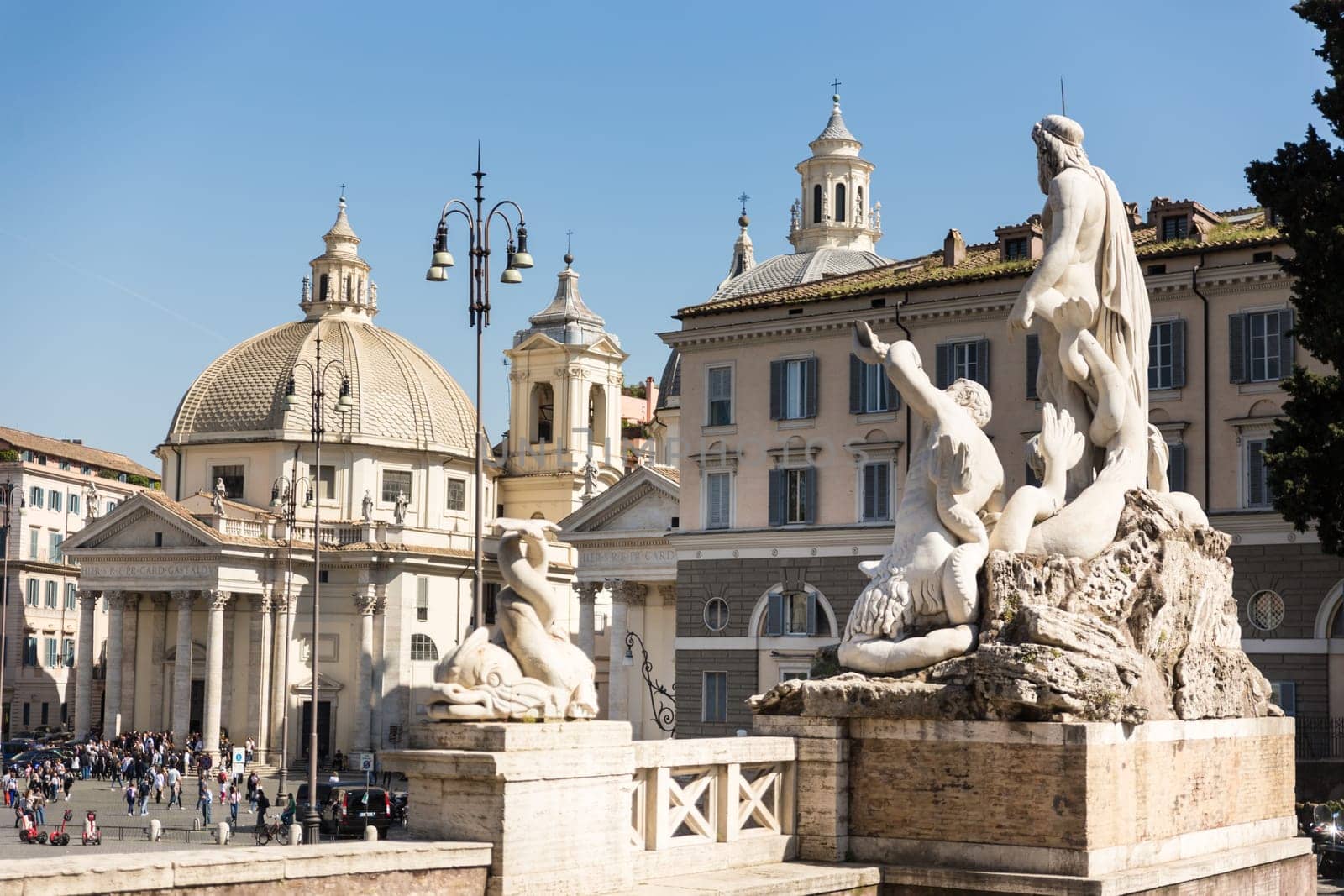 Sculptures and churches on Piazza del Popolo, People's Square, in Rome, Italy.