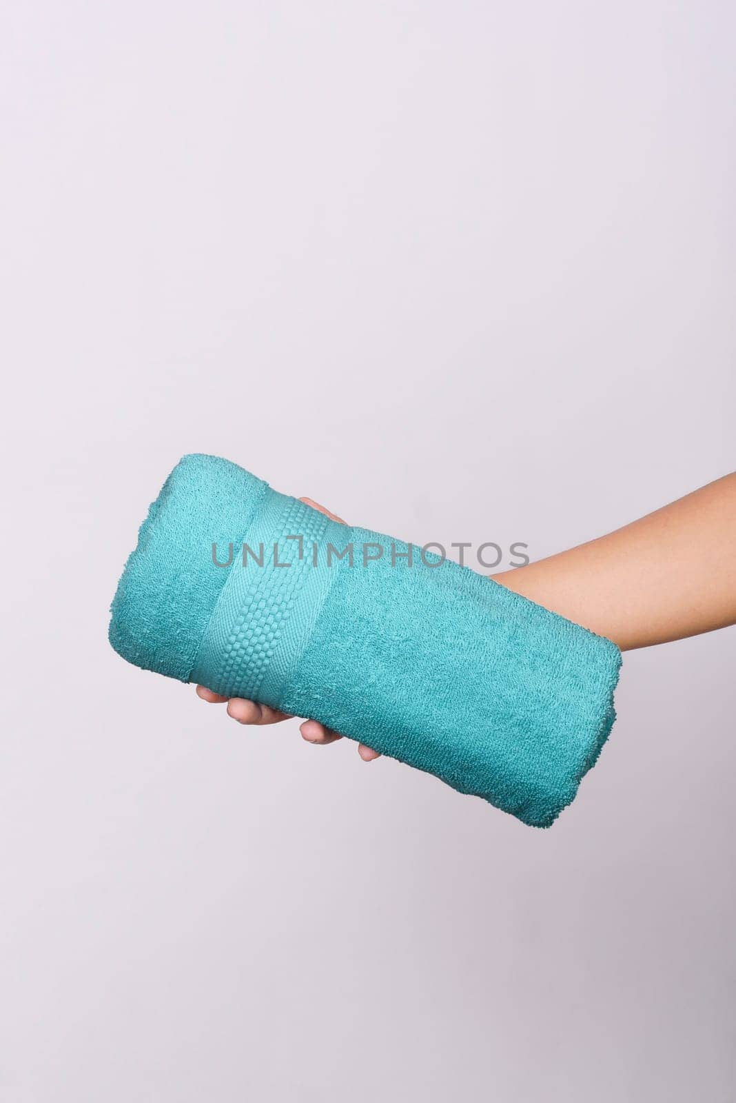 Colored towel on human hands isolated over white background