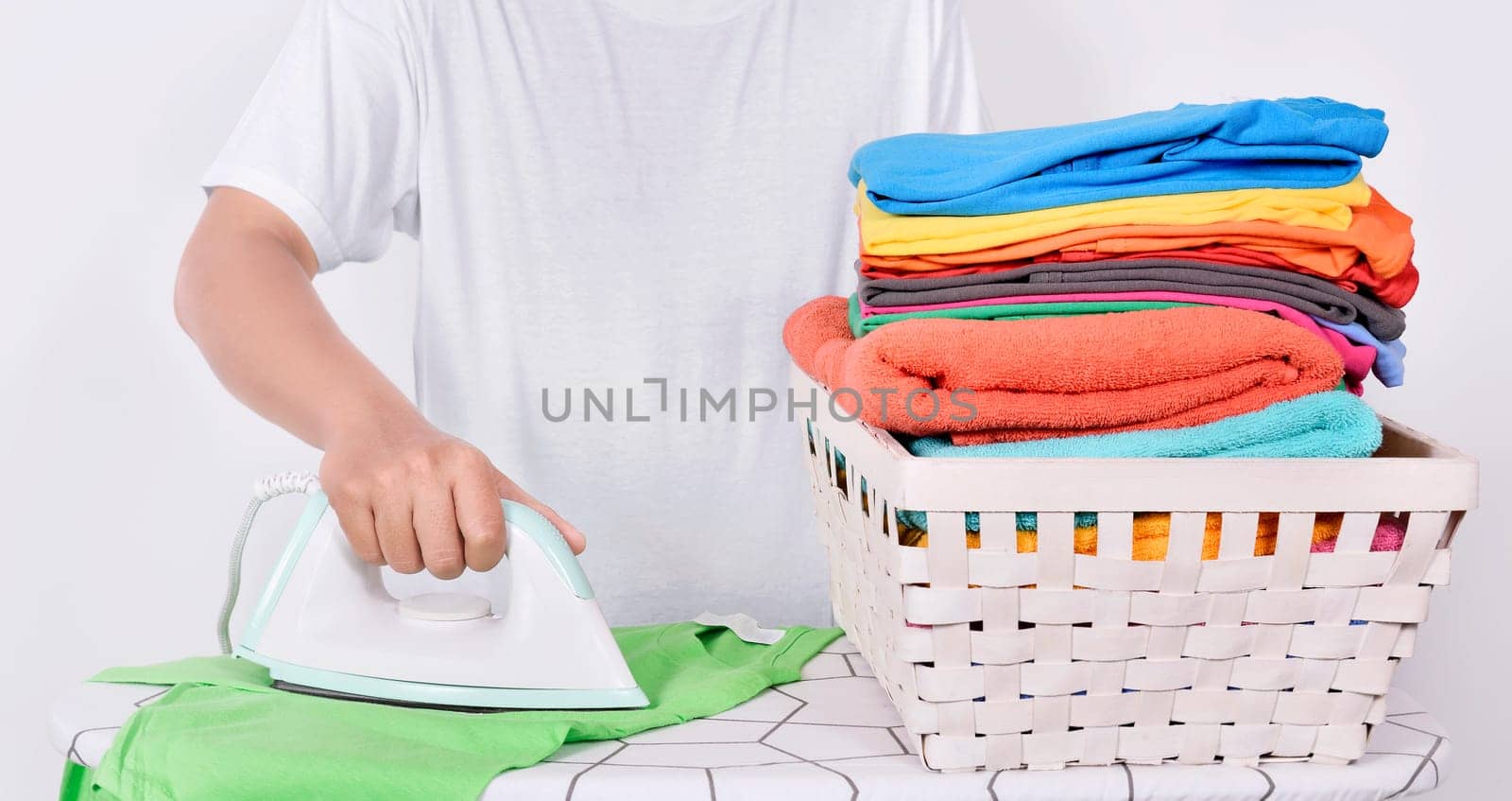 Man ironing clothes on ironing board isolated over white background