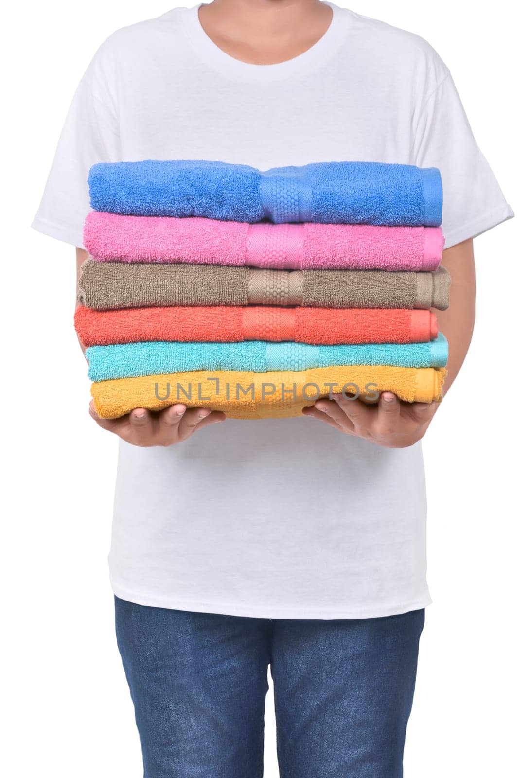 Male hand holding colorful towels pile isolated over white background
