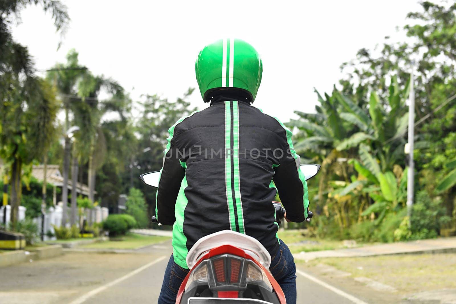 Back view of motorcycle taxi looking for passenger on the street