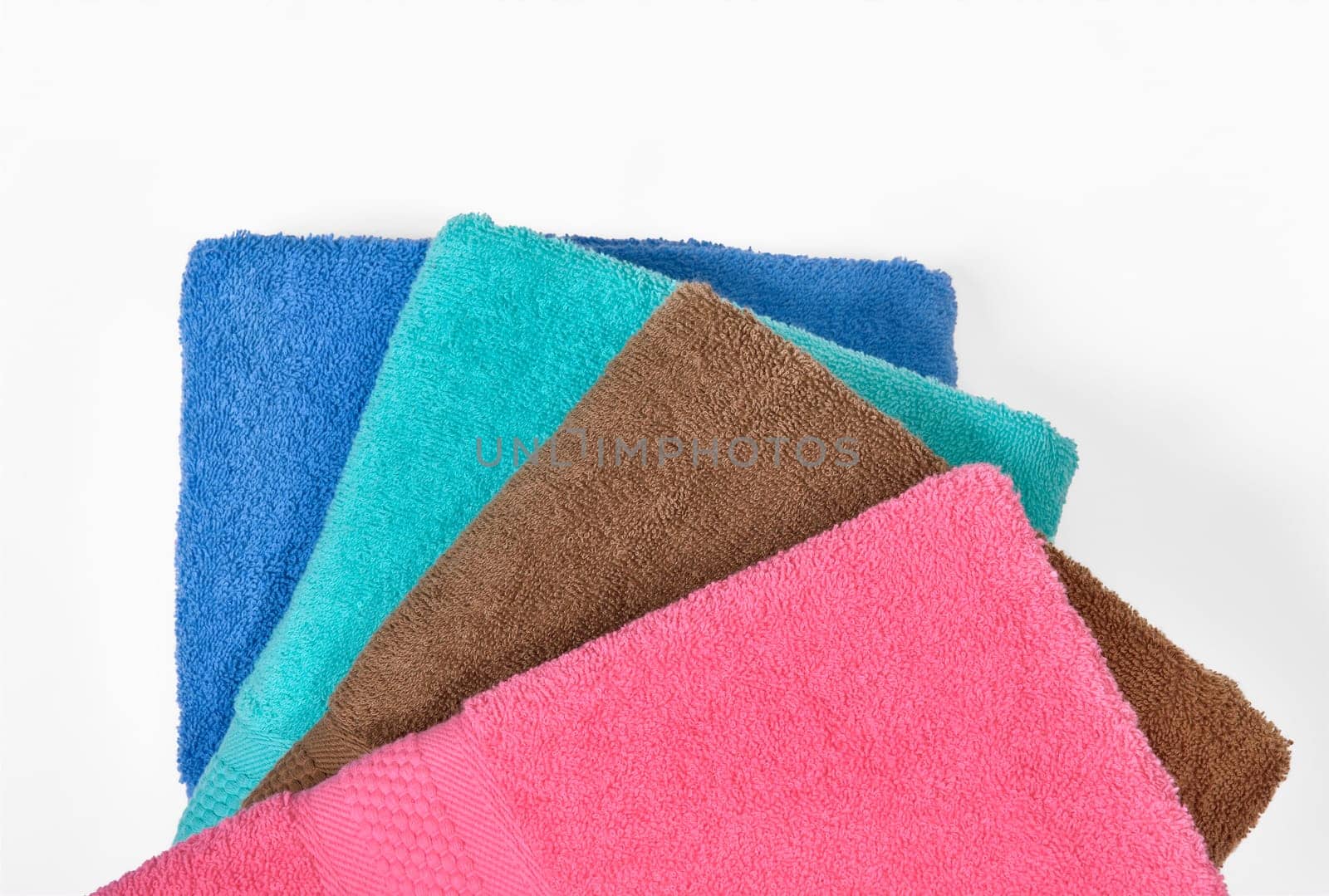 Pile of tidy folded towels isolated over white background