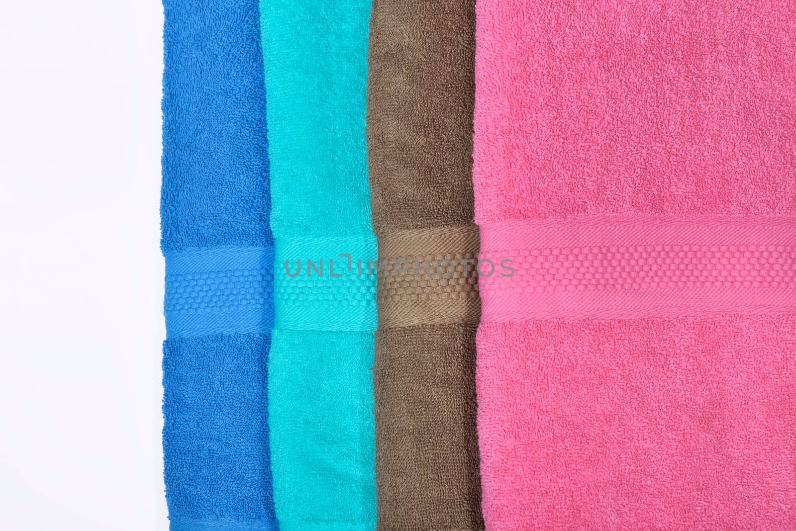 Pile of tidy folded towels isolated over white background