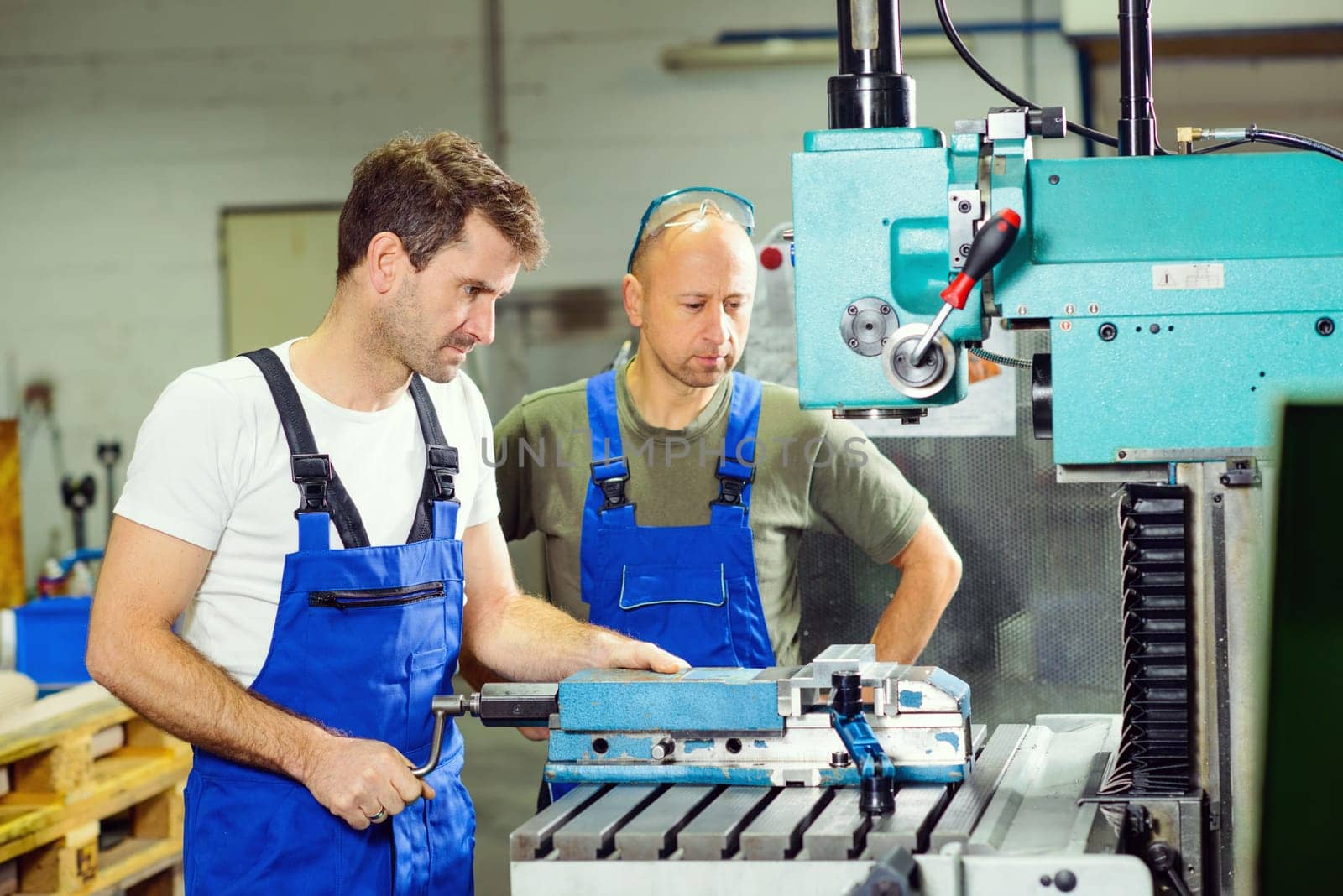 two worker in factory on the machine