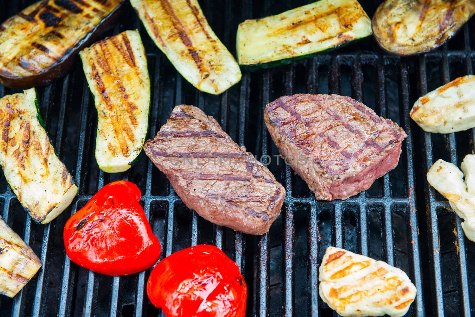 beef steak with different vegetables on barbecue