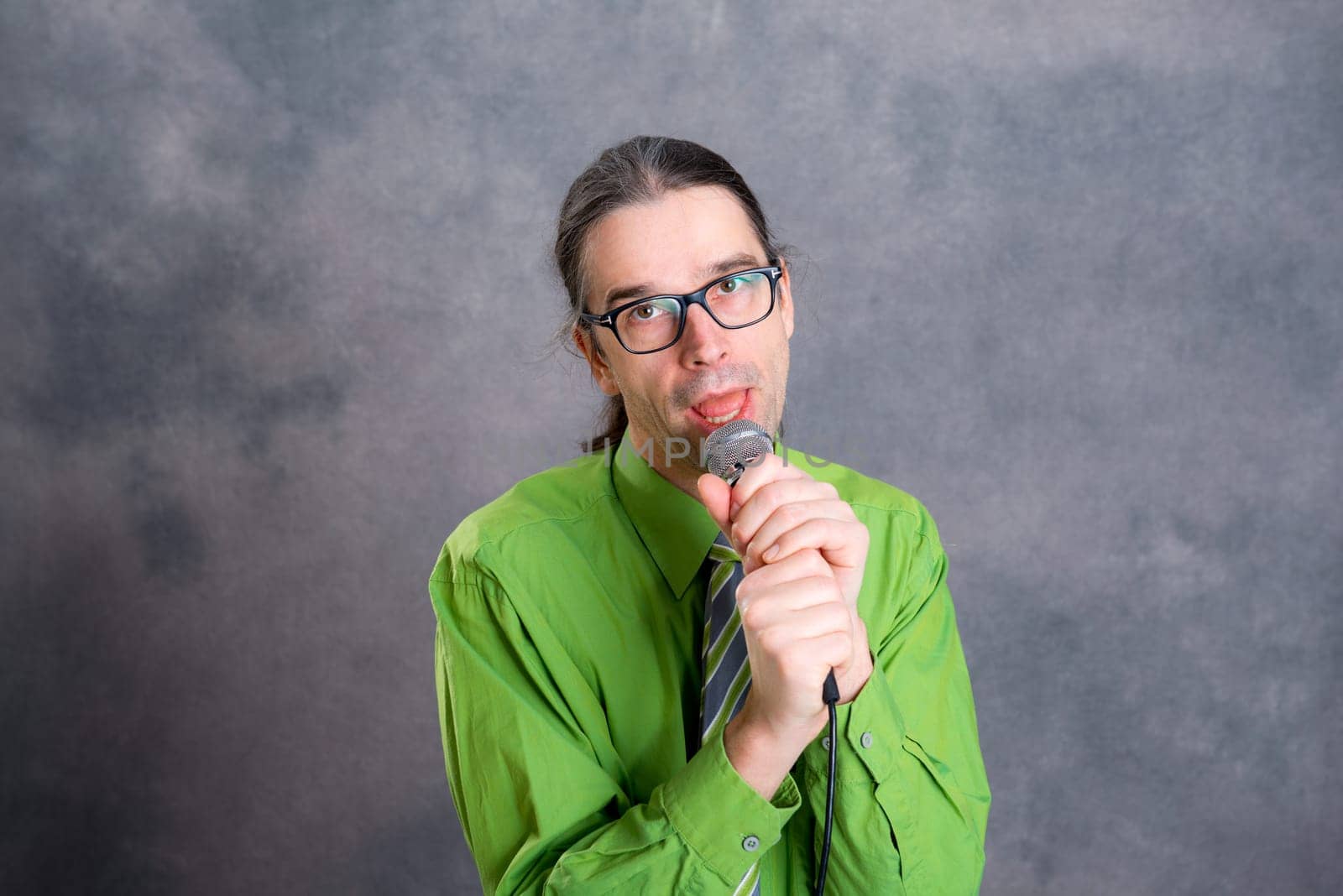 young crooner in green shirt and necktie