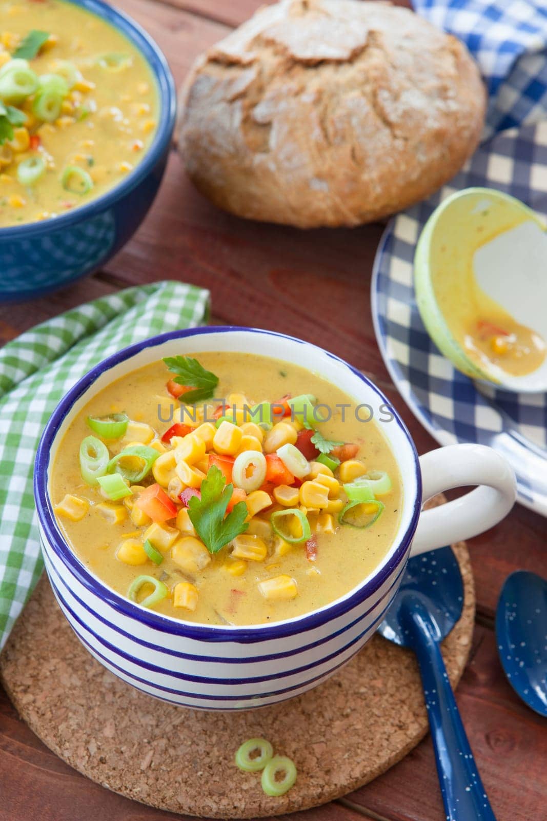 Colorful vegetarian corn chowder with red bell pepper and spring onion