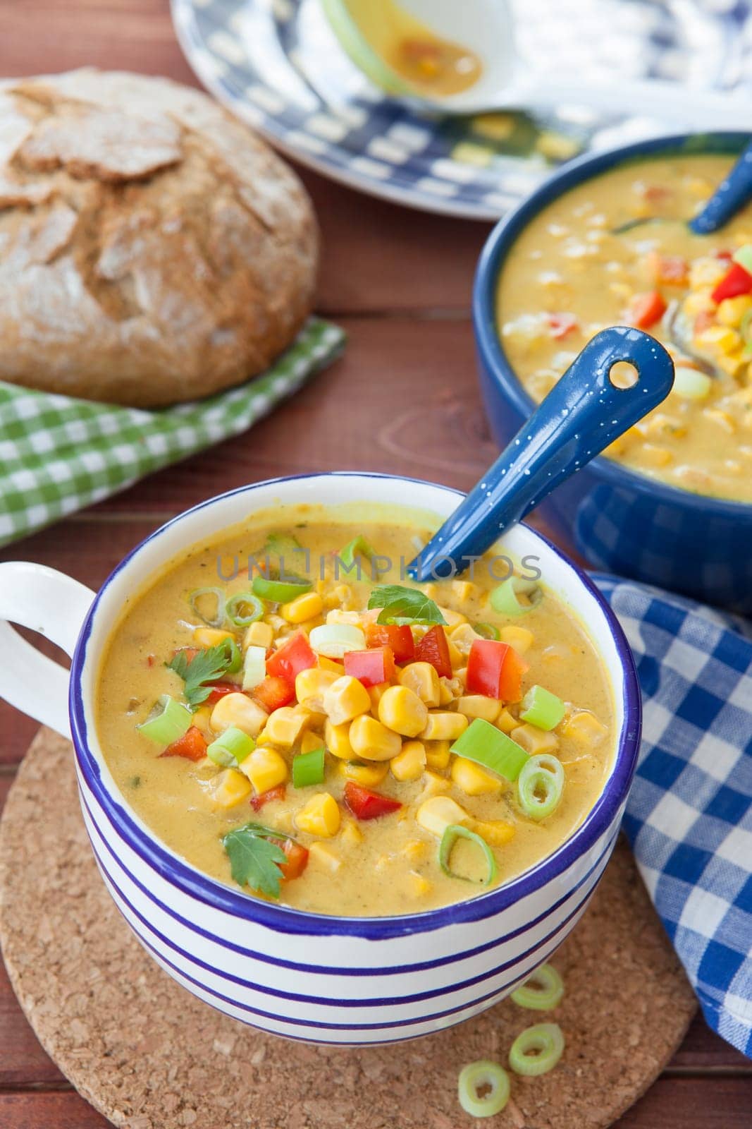 Colorful vegetarian corn chowder with red bell pepper and spring onion