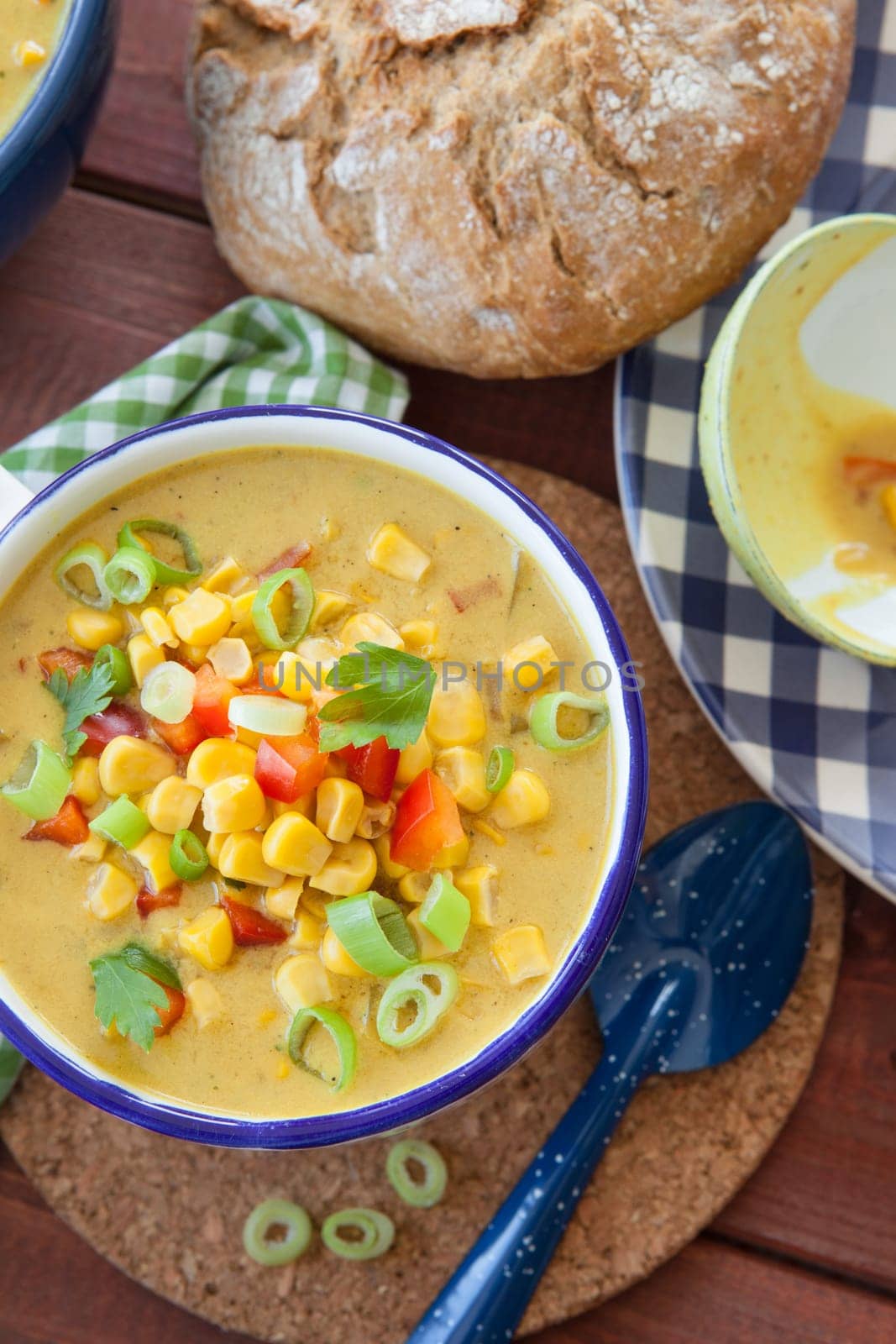 Colorful vegetarian corn chowder with red bell pepper and spring onion