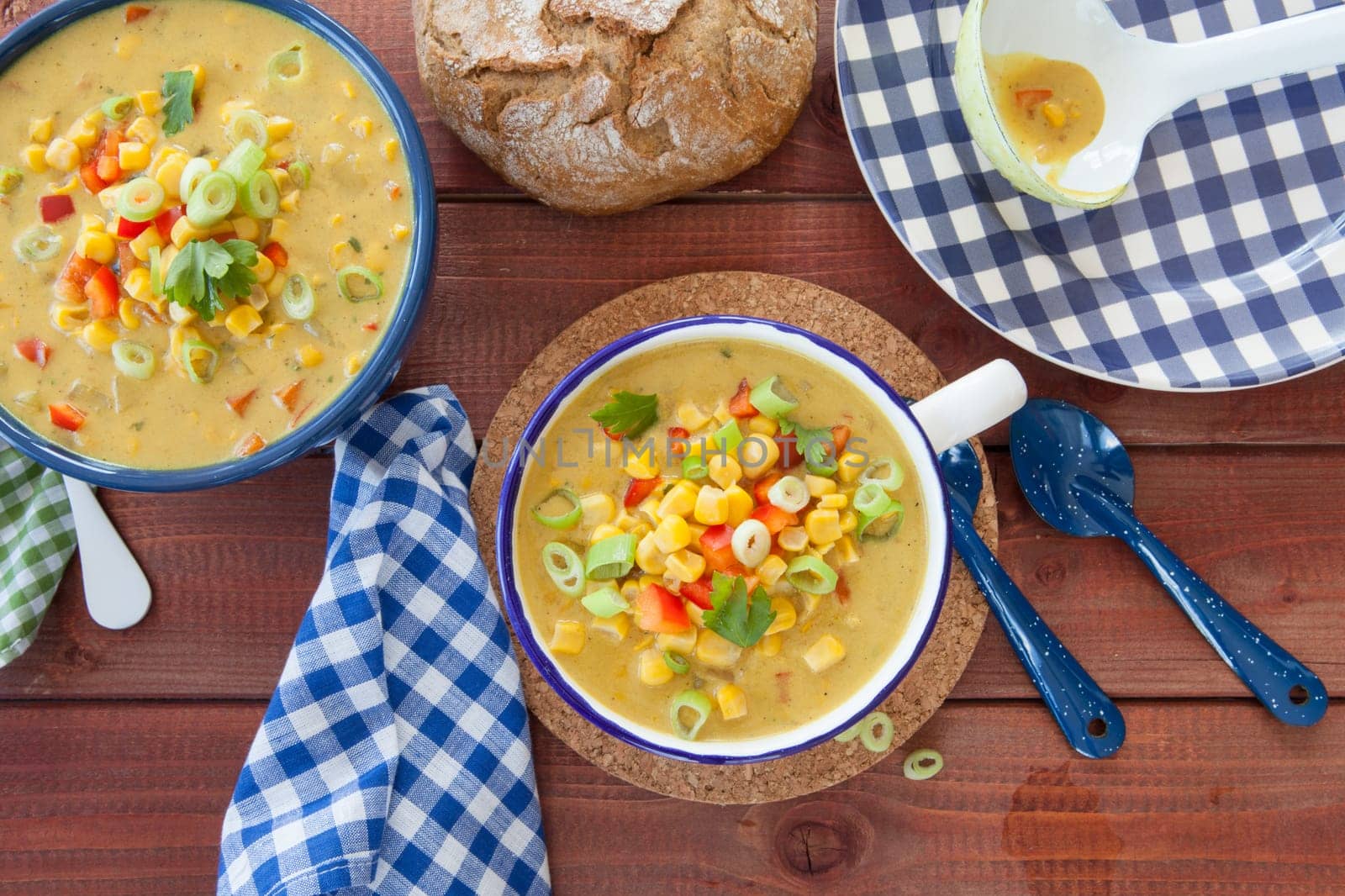 Colorful vegetarian corn chowder with red bell pepper and spring onion