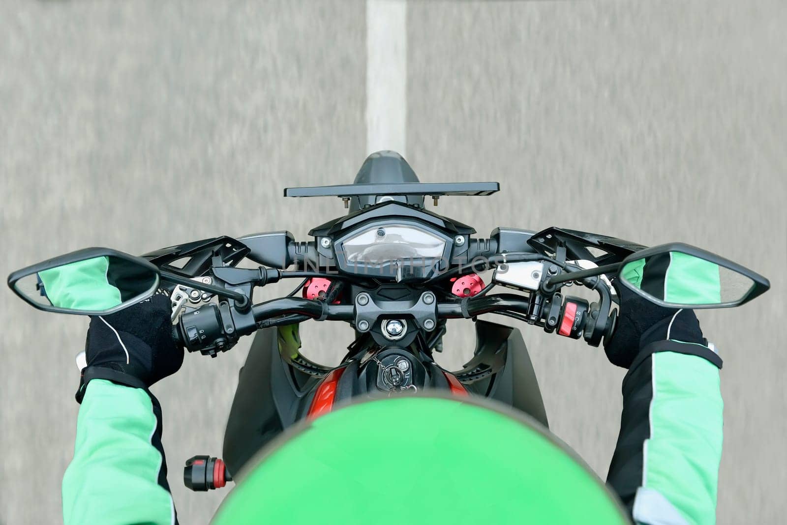 Top view of motorcycle taxi driver while riding on the road