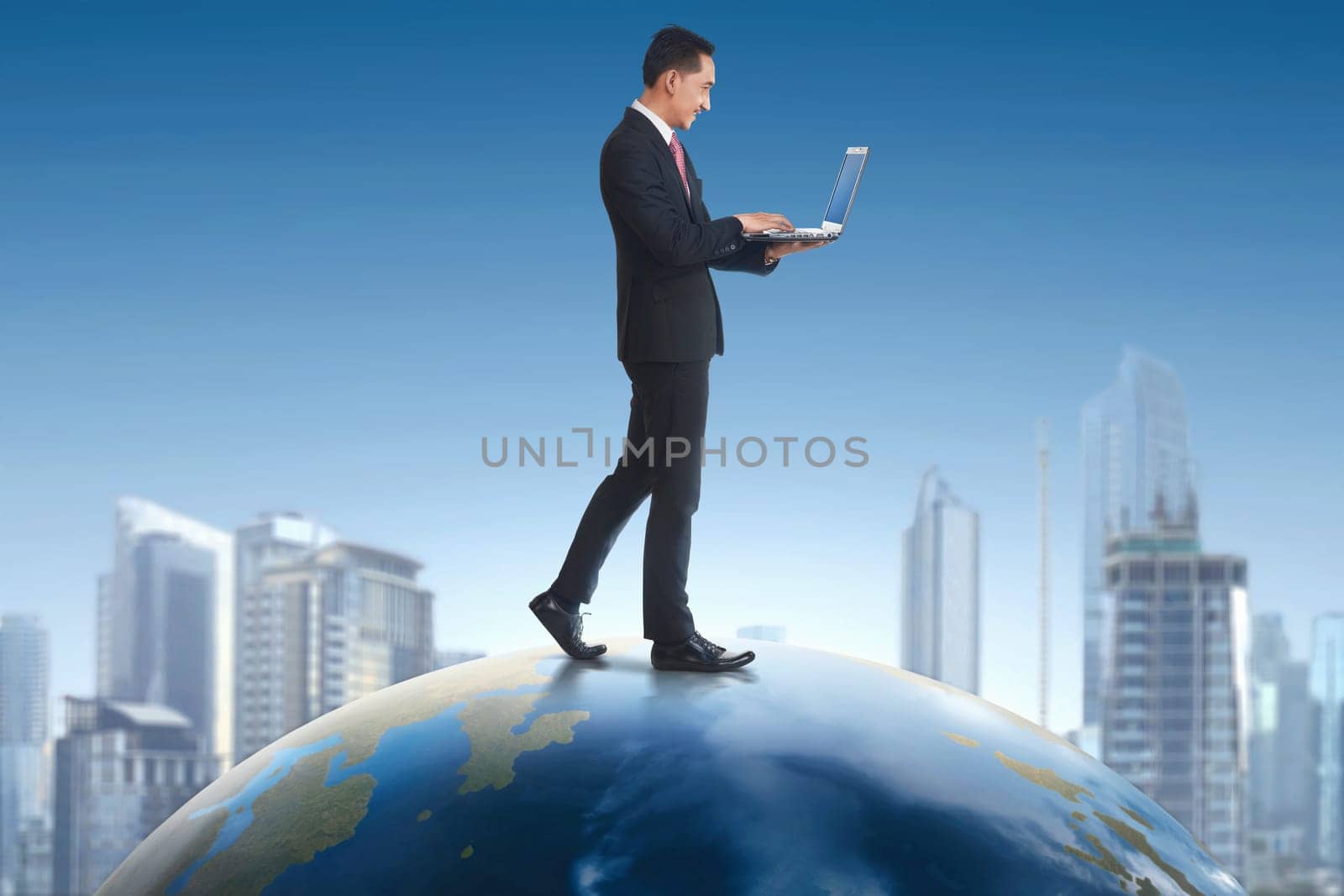 Asian businessman holding laptop while walking on earth with cityscape background